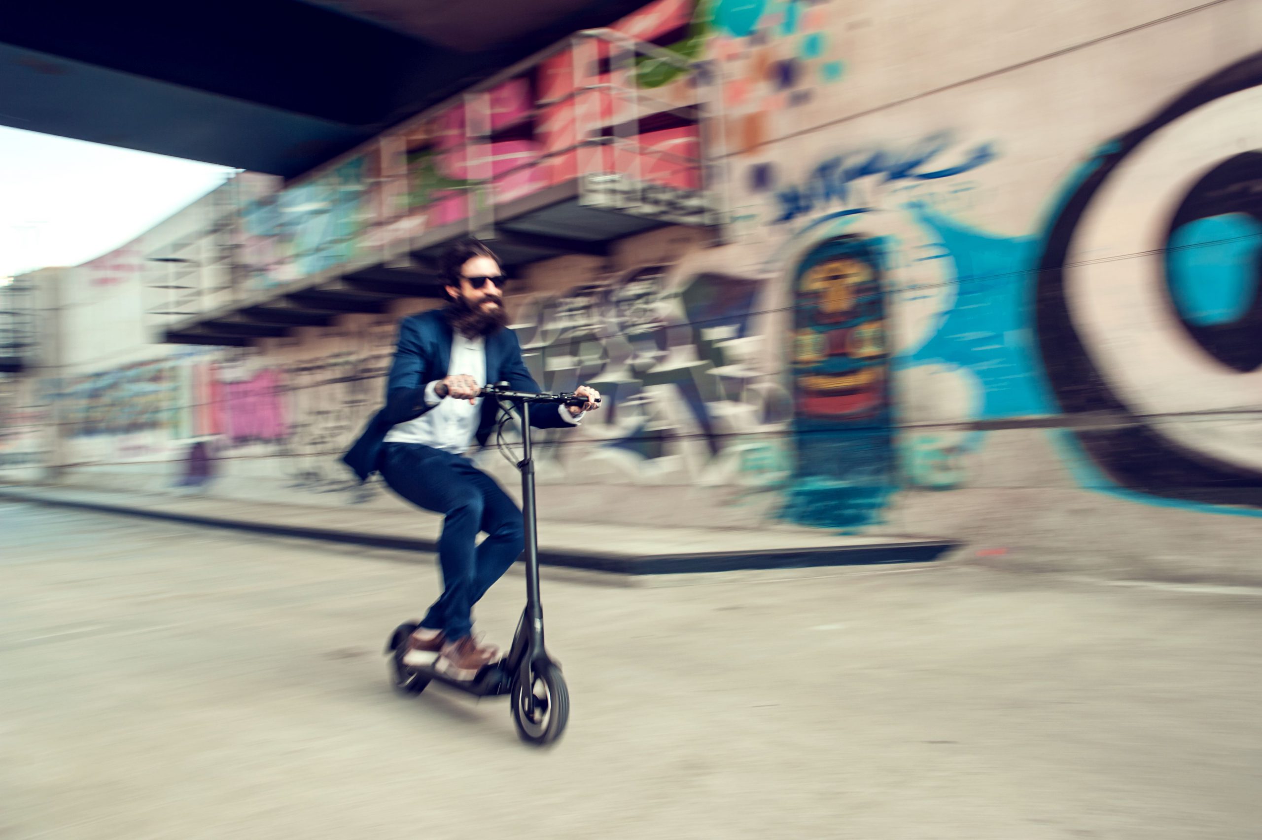 man having fun riding electric scooter